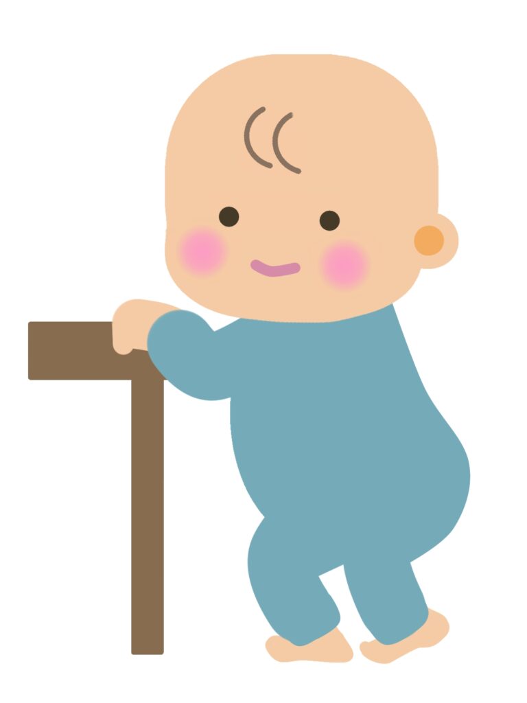 机につかまり立ちをする赤ちゃん
